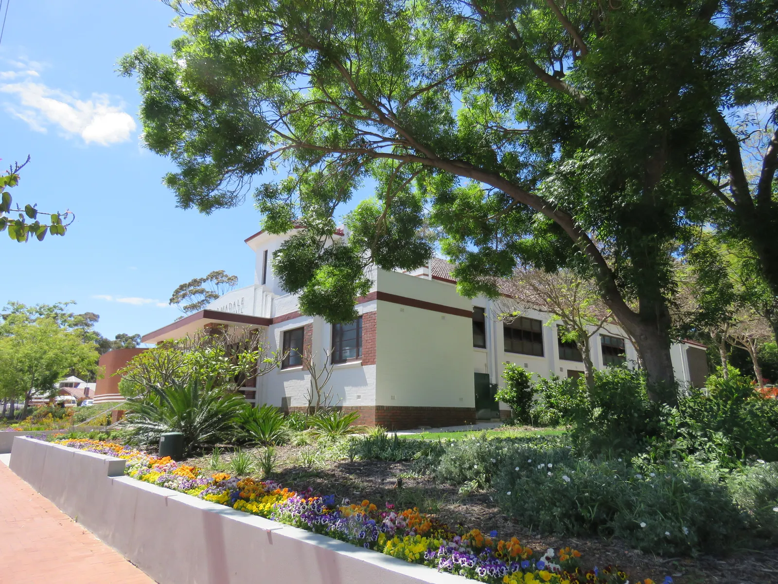 Armadale District Hall with trees, garden beds and a footpath